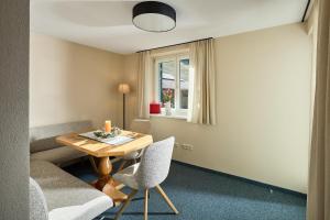 a room with a table and chairs and a window at Landhaus Angelika in Gaschurn +28 photos