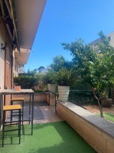 a patio with green grass and a table and chairs at Appartement jardin in Le Cannet
