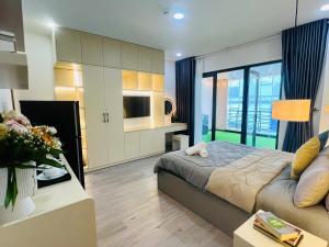a bedroom with a bed and a tv and a couch at Pony Bliss Haven - Sư Vạn Hạnh in Ho Chi Minh City