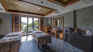a bedroom with two beds and a tv and a window at Angel's Marmaris Hotel in Turgut