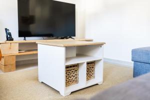 a white desk with a tv on top at Hisa Bubi in Tolmin