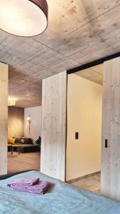 a room with a bed and a living room at Haus am FELS Steinbrech in Hermagor
