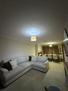 a living room with a couch and a table at Spacious 3 bed semi-detached house in Luton