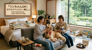 two women sitting on a couch with two dogs at ホテルアドレ大人専用 in Hachinohe
