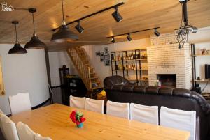 a dining room with a table and a fireplace at Becho House in Becho