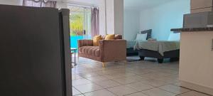 a living room with a couch and a bed at Alldays Sunset Lodge Wilde Street in Alldays