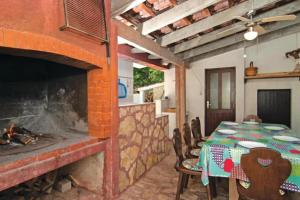 a dining room with a table and a fireplace at Villa Katina Supetar with private pool, pool table, barbecue in Supetar