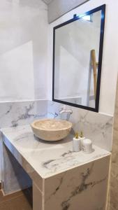 a bathroom with a marble counter with a sink at Panorama Ekas in Ekas