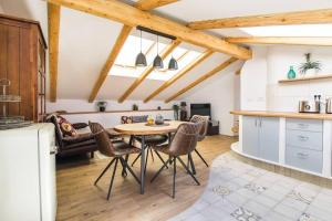 a kitchen and dining room with a table and chairs at Apartma Luna with mountain view in Kobarid