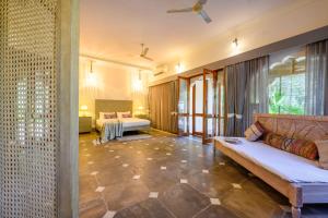 a living room with a couch and a bed at The Bagheera Heritage, Jaipur in Jaipur +73 photos