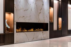 a fireplace in a room with a wall of glass at Rosa Grand Milano - Starhotels Collezione in Milan