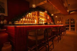 a bar with a row of chairs in a restaurant at The Thane Club in Thane