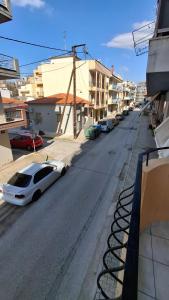 a white car parked on a street with buildings at SweetHome Komotini central & comfy apartment with Parking in Komotini