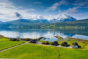 an aerial view of a village on the shore of a lake at Aa-Gård in Tennevoll