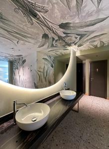 a bathroom with two sinks and a painting on the ceiling at Hotel Bigio in San Pellegrino Terme +160 photos