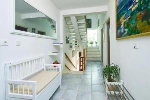 a hallway with a staircase and a painting on the wall at Villa Katina Supetar with private pool, pool table, barbecue in Supetar +39 photos