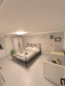 a bedroom with two beds and a brick wall at Apartments Malic in Pridraga