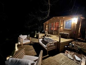 a deck with chairs and a cabin at night at Chalet studio in Porto Ota