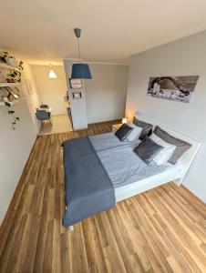 a bedroom with a large bed with a blue blanket at Castle View Apartment in Malbork