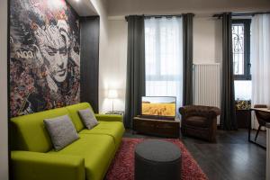 a living room with a yellow couch and a tv at Residence Star in Turin