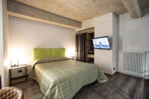 a bedroom with a bed and a flat screen tv at Residence Star in Turin +174 photos