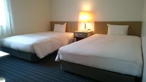 Voodi või voodid majutusasutuse Hotel Crown Hills Sagamihara toas
