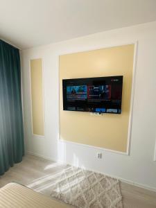 a flat screen tv on a wall in a room at RxM HOME CITY in Chiajna