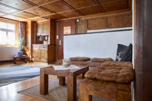 a living room with a couch and a table at Landhaus-Willi in Gaschurn