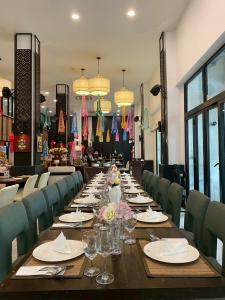a long dining room with a long table and chairs at The Experience Walking Street Chiang Mai in Chiang Mai