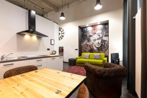 a kitchen with a wooden table and a green couch at Residence Star in Turin