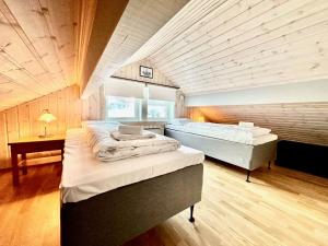 a large room with two beds in it at Nordic Elegance Retreat in Sørvågen