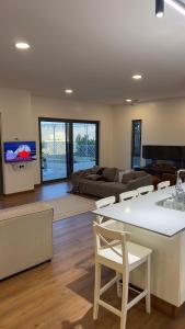 a living room with a couch and a table and chairs at Horizon Villa in Qurayyah