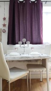 a table with two sinks and a purple curtain at Modern Studio Near Gatwick in London Gatwick Airport