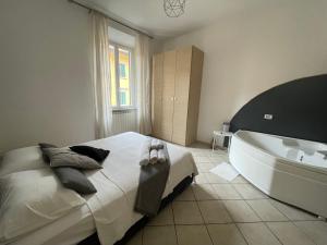 a bedroom with a large bed and a bath tub at Jacuzzi Suite in Livorno