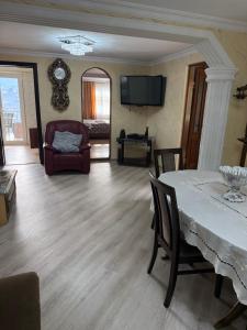 a living room with a table and a couch at tamazis guest house in Batumi