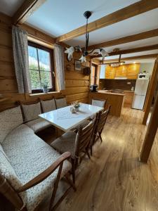 a kitchen and dining room with a table and chairs at Chalupa Nella in Velké Karlovice