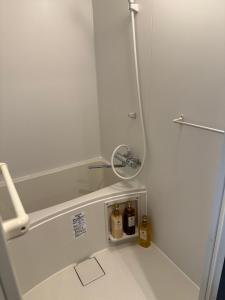 a bathroom with a shower with two bottles in it at 亀井町Stay202 in Takamatsu