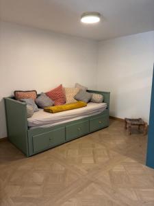 a couch with colorful pillows on it in a room at Loft dans les vignes in La Cadière-dʼAzur