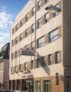 a building with a hotel sign on the side of it at Stadthotel Carinthia in Klagenfurt