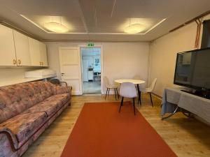 a living room with a couch and a table at Workers Stay - Housing for Workers Olofstorp Göteborg in Olofstorp