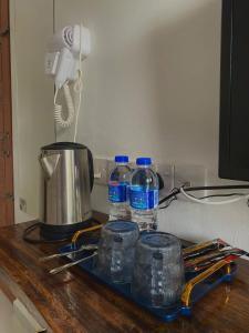 a counter with two bottles of water and a phone at Guest House Gua Kelam in Kaki Bukit
