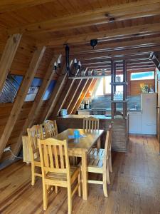 a dining room with a wooden table and chairs at Ferienhaus Finnhütte in Zinnowitz