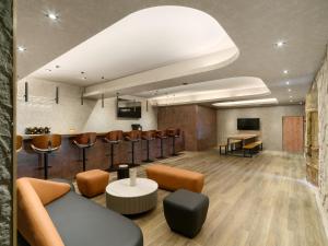 a lobby with a waiting room with a couch and chairs at The Zen in Jiufen