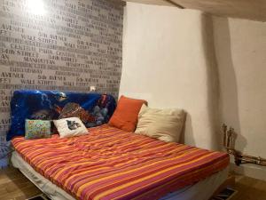 a bed in a room with a wall at Longère en campagne in Maisonnay