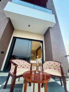 a table with two chairs and a bottle of wine at Riviera Hotel and Resort in Choli