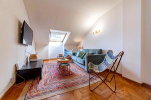 a living room with a couch and a table at Apartamento Bautista Centro in Cangas de Onís