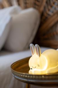 a small yellow toy rabbit sitting on a plate at Apartamento Bautista Centro in Cangas de Onís