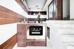 a lobby with a counter with a sign on it at Super Collection O Maninagar Formerly Park Land in Ahmedabad