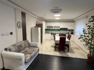 a living room with a couch and a table at Star Street Home in Mosonmagyaróvár