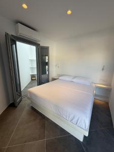 a bedroom with a white bed and a large window at Maison Blanche in Vóthon